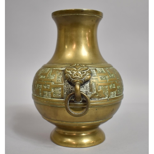 298 - A Chinese Bronze Altar Vase of Baluster Form with Lion Mask Ring Handles. 18cms High