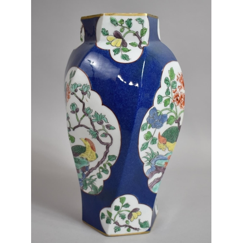 387 - A Chinese Powder Blue Octagonal Vase of Shaped Form with Floral Cartouches. 31cms High