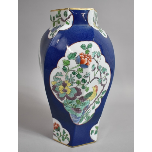 387 - A Chinese Powder Blue Octagonal Vase of Shaped Form with Floral Cartouches. 31cms High