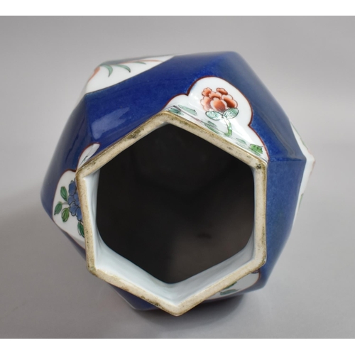 387 - A Chinese Powder Blue Octagonal Vase of Shaped Form with Floral Cartouches. 31cms High