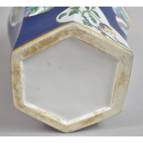 387 - A Chinese Powder Blue Octagonal Vase of Shaped Form with Floral Cartouches. 31cms High