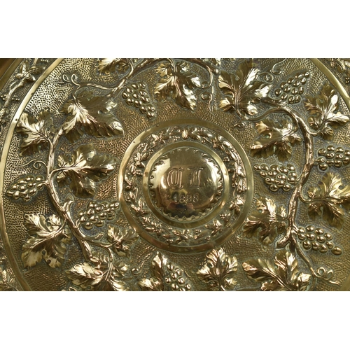 197 - A Late 19th Century Hand Beaten Circular Brass Plate decorated with Grape and Vine Leaf Motif having... 