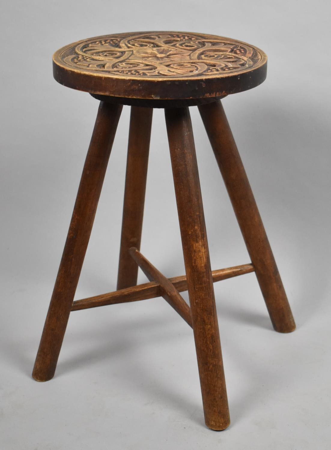 An Edwardian Carved Oval Topped Four Legged Stool 45cm high