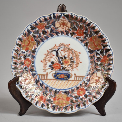 320 - A 19th Century Oriental Porcelain Scalloped Edge Plate Decorated in the Imari Palette, Under Blue an... 