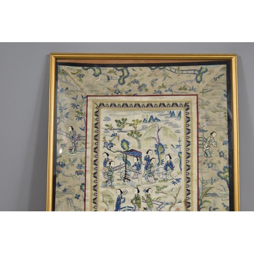 222 - A Framed Chinese Silk Embroidered Sleeve Panel Depicting Maidens in Exterior Garden Setting.