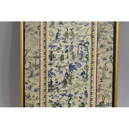 222 - A Framed Chinese Silk Embroidered Sleeve Panel Depicting Maidens in Exterior Garden Setting.