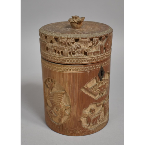 254 - A Chinese Cylindrical Bamboo Tea Caddy having Intricately Carved Decoration Depicting Elder Scholars... 