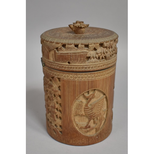 254 - A Chinese Cylindrical Bamboo Tea Caddy having Intricately Carved Decoration Depicting Elder Scholars... 