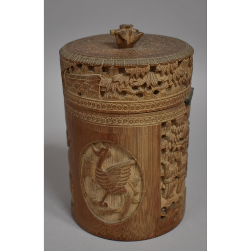 254 - A Chinese Cylindrical Bamboo Tea Caddy having Intricately Carved Decoration Depicting Elder Scholars... 