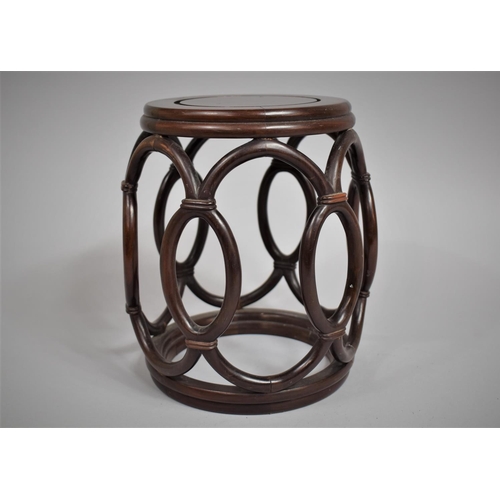 242 - A Chinese Hardwood Drum Shaped Vase Stand, 16cms Diameter and 23cms High