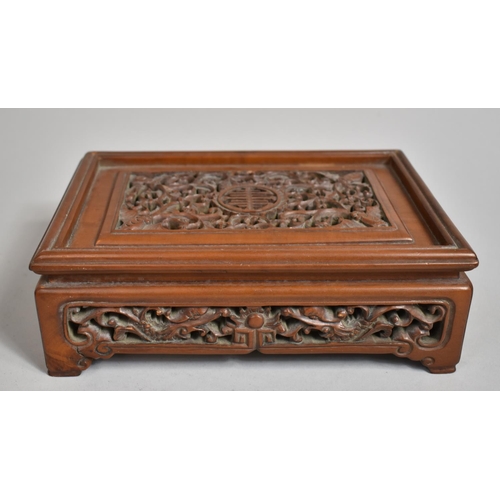 243 - A Chinese Cherry Wood Pierced and Carved Rectangular Stand decorated with Bats, Vines and Dragons an... 