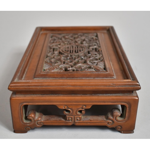 243 - A Chinese Cherry Wood Pierced and Carved Rectangular Stand decorated with Bats, Vines and Dragons an... 