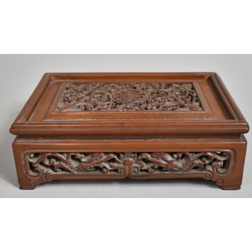 243 - A Chinese Cherry Wood Pierced and Carved Rectangular Stand decorated with Bats, Vines and Dragons an... 