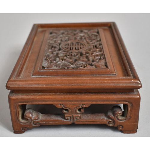 243 - A Chinese Cherry Wood Pierced and Carved Rectangular Stand decorated with Bats, Vines and Dragons an... 