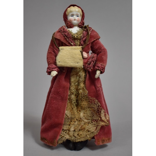 62 - A Small Victorian Porcelain Head Doll with Original Velvet and Lace clothing