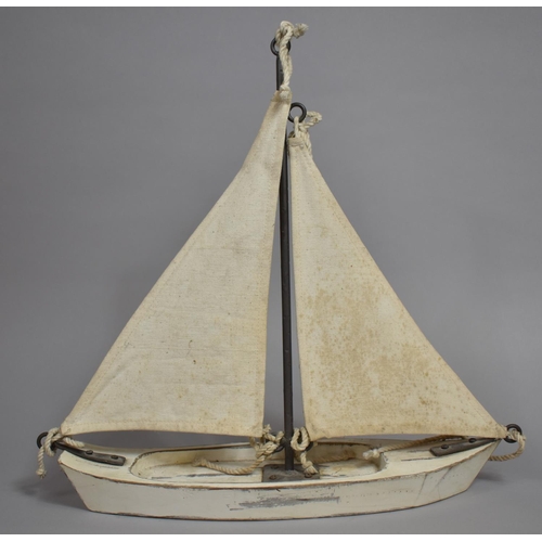 67 - A Mid 20th Century Folk Art Pond Yacht with Canvas Sails and Wooden Hull. 42x13x42cms