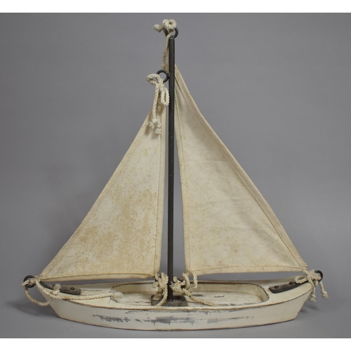 67 - A Mid 20th Century Folk Art Pond Yacht with Canvas Sails and Wooden Hull. 42x13x42cms