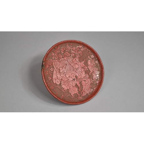 97 - A Japanese Red Cinnabar Circular Card Tray on Three Feet. Decorated in Relief with Figures Dancing i... 