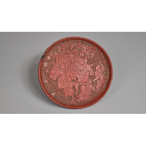 97 - A Japanese Red Cinnabar Circular Card Tray on Three Feet. Decorated in Relief with Figures Dancing i... 