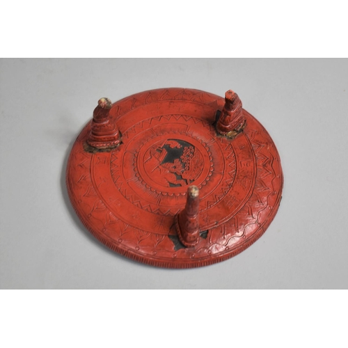 97 - A Japanese Red Cinnabar Circular Card Tray on Three Feet. Decorated in Relief with Figures Dancing i... 