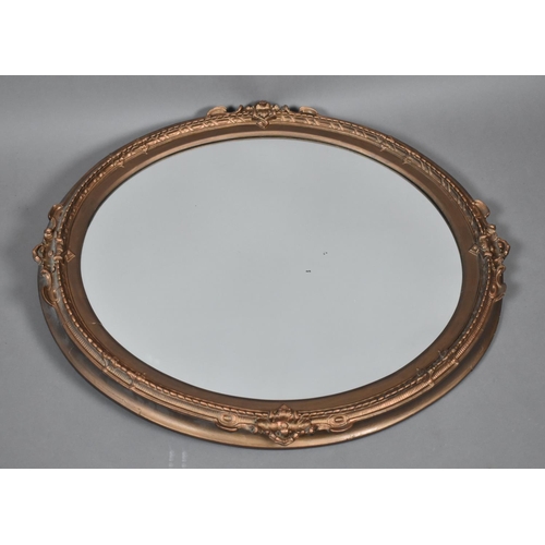 234 - A Gilt Framed Oval Wall Mirror with Moulded Frame, 66x59cm