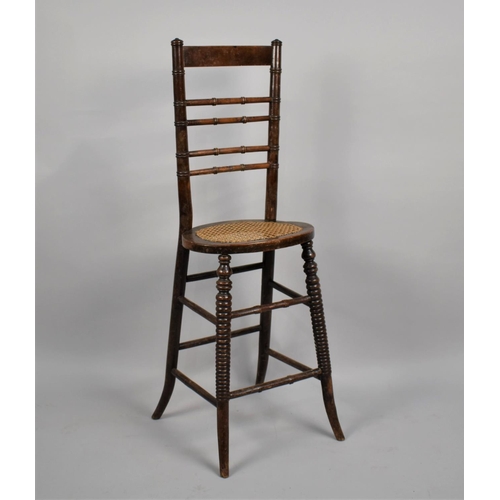 469 - A 19th Century Faux Bamboo, Cane Seated, Correction Chair with stylised stretchers, has been wormed,... 