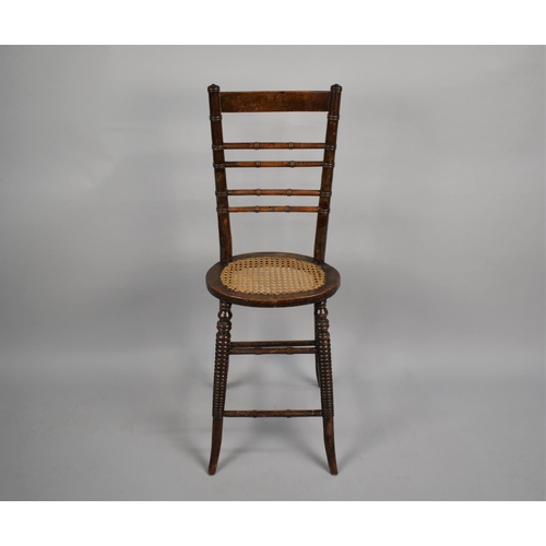 469 - A 19th Century Faux Bamboo, Cane Seated, Correction Chair with stylised stretchers, has been wormed,... 