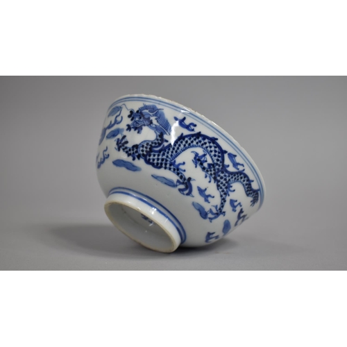 273 - A Chinese Porcelain Blue and White Bowl Decorated with Dragons Chasing Flaming Pearl Amongst Clouds ... 