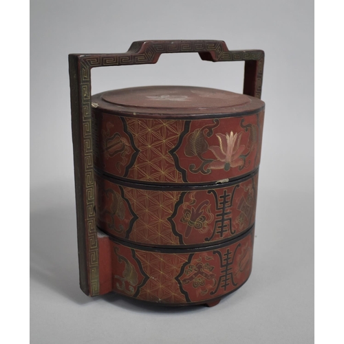 222 - A 19th Century Chinese Red Lacquer Three Tier Food Basket, Circular form with Carry Handle, Decorate... 