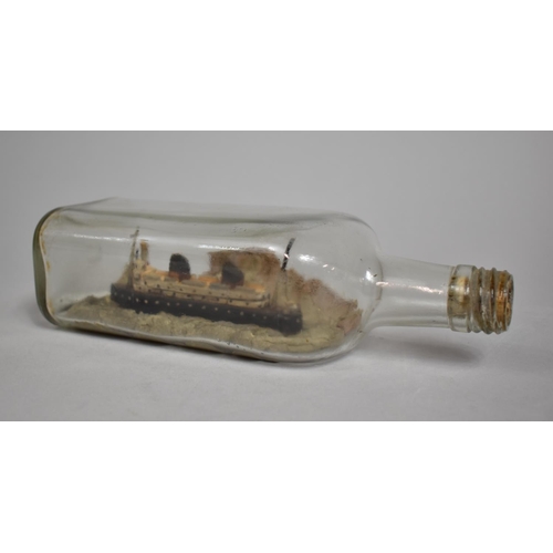 56 - An Early 20th Century Folk Art Ship in a Bottle, Passenger Liner with Light House and Rocky Land, 24... 