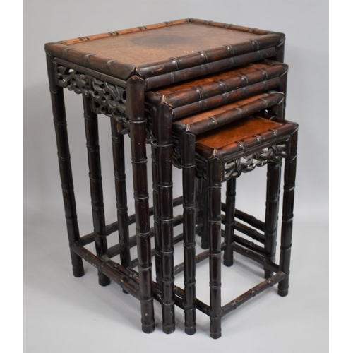 207 - A Chinese Hardwood Nest of Tables, the Supports with Faux Bamboo stylisation and Carved and Pierced ... 