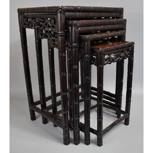 207 - A Chinese Hardwood Nest of Tables, the Supports with Faux Bamboo stylisation and Carved and Pierced ... 