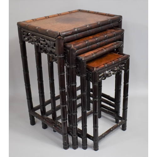 207 - A Chinese Hardwood Nest of Tables, the Supports with Faux Bamboo stylisation and Carved and Pierced ... 