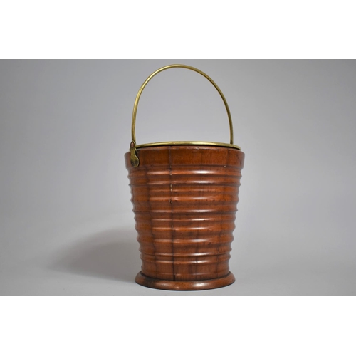 22 - A 19th Century Turned Wooden Bucket, of small proportions and of tapering form, brass handle and lin... 