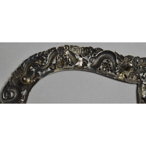 249 - A Chinese Silver Heart Shaped Photo Frame with Repousse decoration depicting Dragons Chasing Flaming... 