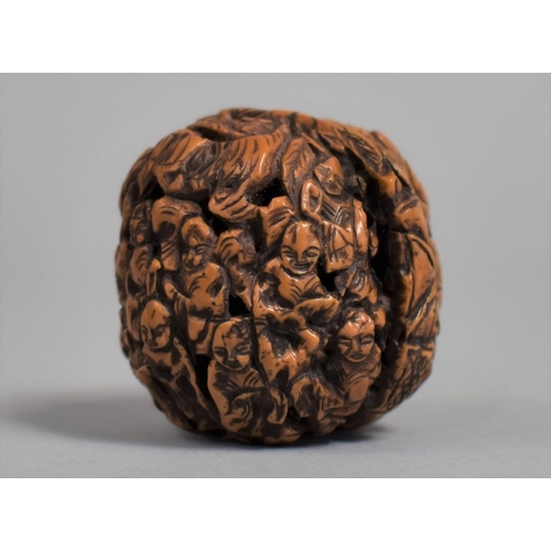 226 - A Chinese Carved Walnut Shell Decorated with Figures and Pagoda