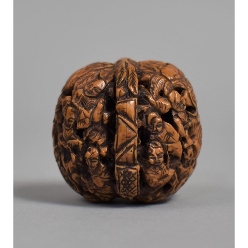 226 - A Chinese Carved Walnut Shell Decorated with Figures and Pagoda