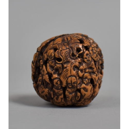 226 - A Chinese Carved Walnut Shell Decorated with Figures and Pagoda