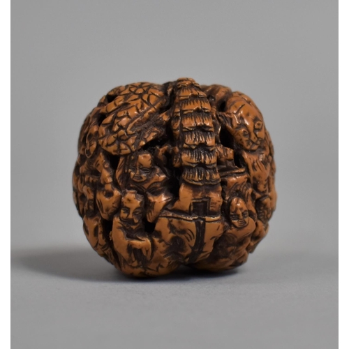 226 - A Chinese Carved Walnut Shell Decorated with Figures and Pagoda