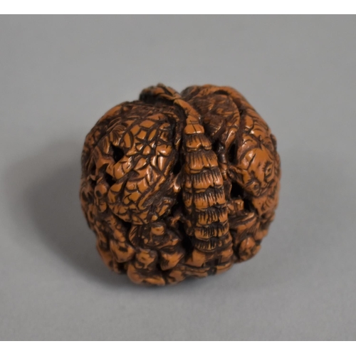 226 - A Chinese Carved Walnut Shell Decorated with Figures and Pagoda