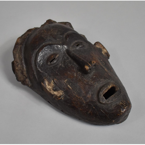 66 - An African Carved Wooden Pan Type Tribal Mask, 25cm high