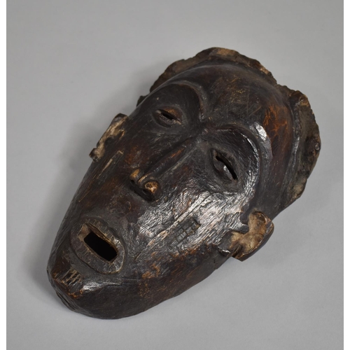 66 - An African Carved Wooden Pan Type Tribal Mask, 25cm high