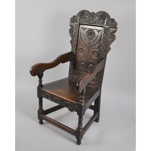 467 - A 18th Century Joined Oak Wainscot Armchair with carved back rest having floral motif design, surmou... 