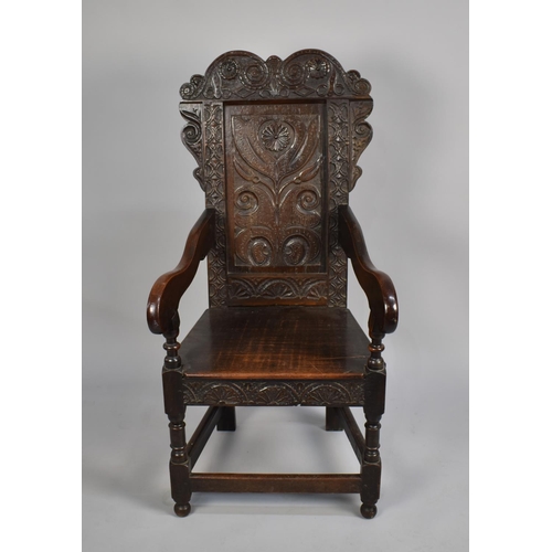 467 - A 18th Century Joined Oak Wainscot Armchair with carved back rest having floral motif design, surmou... 