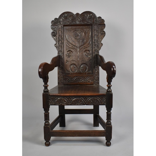 467 - A 18th Century Joined Oak Wainscot Armchair with carved back rest having floral motif design, surmou... 