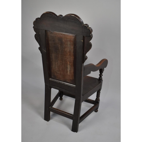 467 - A 18th Century Joined Oak Wainscot Armchair with carved back rest having floral motif design, surmou... 