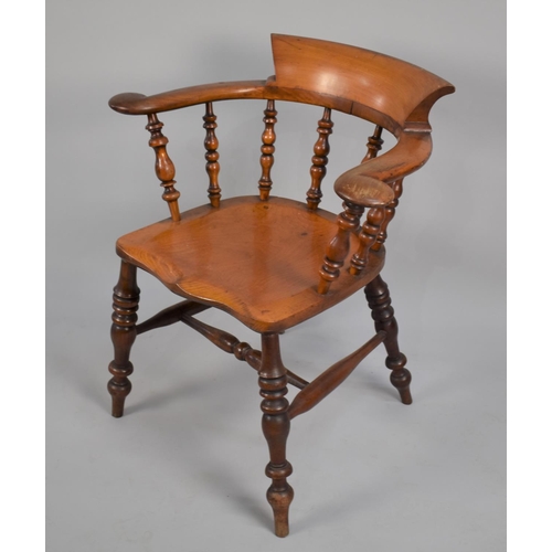 466 - A 19th Century Elm Seated Captains Chair, with spindle back and turned legs to central stretcher