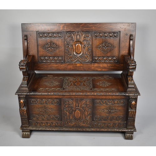 99 - A Carved Oak Monks Bench with Hinged Seat and Having Heavily Carved Panels and Back Rest, with Carve... 