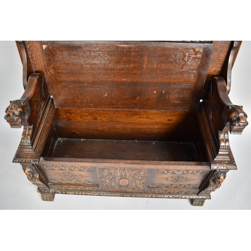 99 - A Carved Oak Monks Bench with Hinged Seat and Having Heavily Carved Panels and Back Rest, with Carve... 