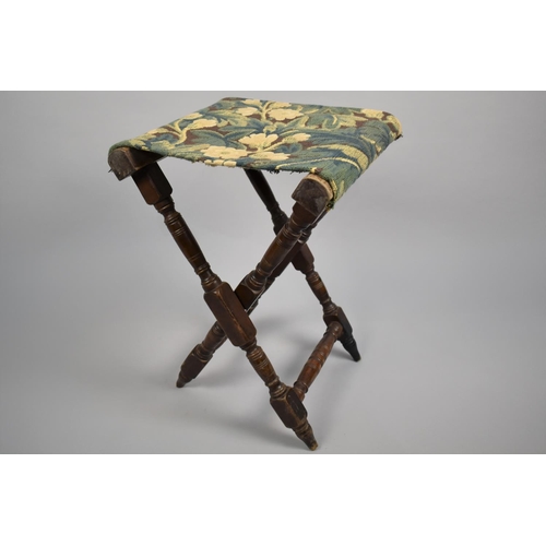 46 - A 19th Century Folding Campaign Stool with a Tapestry Seat, 57cms High
